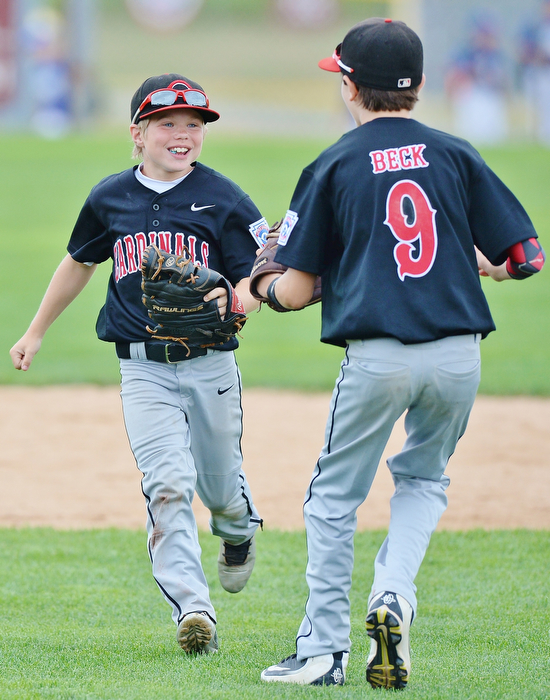 Jeff Lange | The Vindicator  THU, JUL 28, 2016 - Canfield outfielder Ty Stricko (left) celebrates with Jameson Beck after catching a fly ball to end the top of the fifth inning against Hamilton West Side Thursday afternoon at Fields of Dreams in Boardman.