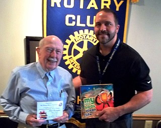 SPECIAL TO THE VINDICATOR
William Farragher, retired communications director for Youngstown Sheet and Tube, was the guest speaker for Austintown Rotary on July 25. Farragher discussed the circumstances leading to his appointment as project manager of the 630-feet tall Gateway Arch monument in St. Louis during its construction between February 1963 and October 1965. He successfully maintained his full-time executive status with Youngstown Sheet and Tube while he worked on the monument. From left, are Farragher, and Edward Kalaher, rotary president.