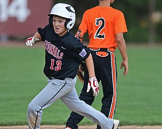 BOARDMAN, OHIO - JULY 29, 2016: Luca Ricchiuti(13) of Canfield rounds second base for a RBI triple in the second inning of Friday evenings Little League game at the Fields of Dreams. Canfield would go on to win, 12-2. DAVID DERMER | THE VINDICATOR