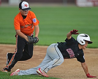 BOARDMAN, OHIO - JULY 29, 2016: Ben Slanker(14) of Canfield dives back to first base to avoid the tag from first baseman Landon Spearman(9) of Mount Vernon, but would be ruled an out for running out of the baseline in the second inning of Friday evenings Little League game at the Fields of Dreams. Canfield would go on to win, 12-2.  DAVID DERMER | THE VINDICATOR