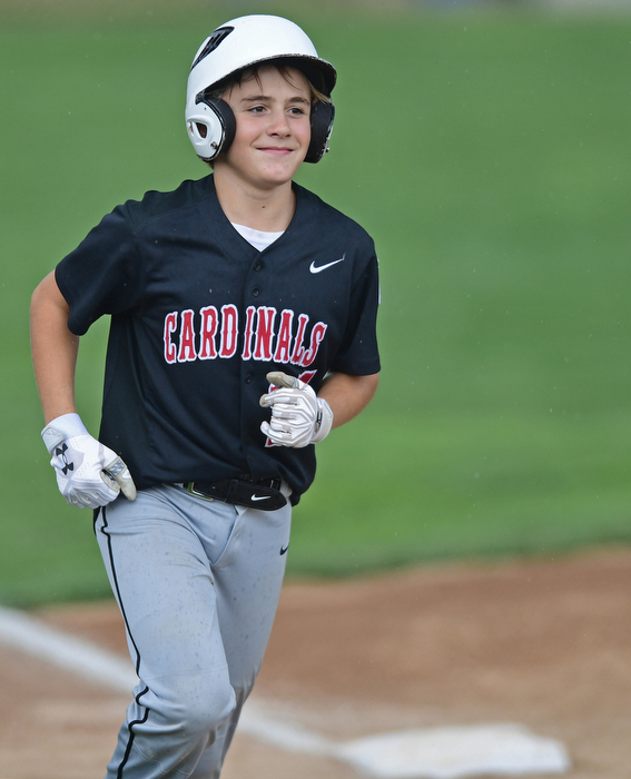BOARDMAN, OHIO - JULY 29, 2016: Broc Lowry(27) of Canfield smiles while jogging the bases after hitting a two run home run in the second inning of Friday evenings Little League game at the Fields of Dreams. Canfield would go on to win, 12-2. DAVID DERMER | THE VINDICATOR
