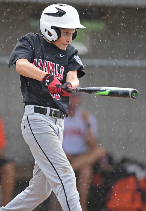 BOARDMAN, OHIO - JULY 29, 2016: Jake Schneider(12) of Canfield finishes his swing after blasting a three run home run in the fourth inning of Friday evenings Little League game at the Fields of Dreams. Canfield would go on to win, 12-2. DAVID DERMER | THE VINDICATOR