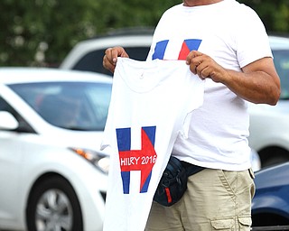 Nikos Frazier | The Vindicator..Jim Engels of Charolette, NC. holds his merchandise outside of East High School before Democratic Presidential candidate Hillary Clinton spoke on Saturday night. Engels has been selling merchandise on the Democratic campaign trail for the bast 10 months.