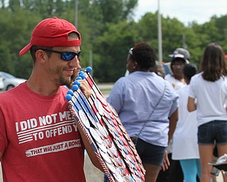 Nikos Frazier | The Vindicator..Josh Evans, of Springfield, Missouri sells "Hillary for President" buttons outside of East High School before Democratic Presidential candidate Hillary Clinton spoke on Saturday night.