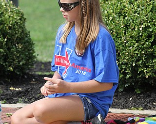 Nikos Frazier | The Vindicator..Hailie-Marie Flood, 9, of Vienna plays cards with her mom outside of East High School before Democratic Presidential candidate Hillary Clinton spoke on Saturday night.