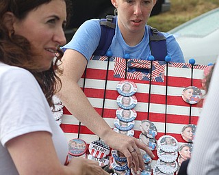 Nikos Frazier | The Vindicator..Stefanie Miranda of Arkansas sells Hillary buttons outside of East High School before Democratic Presidential candidate Hillary Clinton spoke on Saturday night.