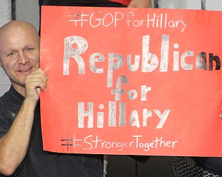 Nikos Frazier | The Vindicator..Sean Cornelius of Austintown holds a "Republican for Hillary" in the East High School gym before Democratic Presidential candidate Hillary Clinton spoke on Saturday night.