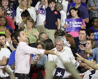 Nikos Frazier | The Vindicator..An organizer throws water to waiting Clinton supporters in the East High School gym before Democratic Presidential candidate Hillary Clinton spoke on Saturday night.