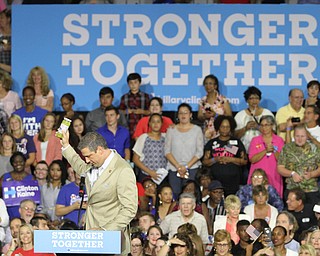 Nikos Frazier | The Vindicator..Congressman Tim Ryan holds a jar of hot peppers for Hillary Clintonin the East High School gym before Democratic Presidential candidate Hillary Clinton spoke on Saturday night.