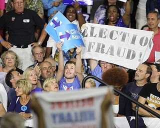 Nikos Frazier | The Vindicator..A protestor holds a "election Fraud" sign in the East High School gym before Democratic Presidential candidate Hillary Clinton spoke on Saturday night.