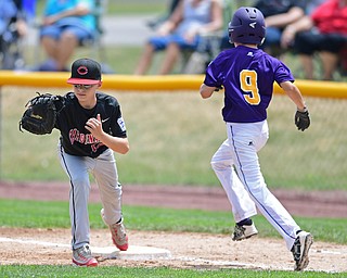 BOARDMAN, OHIO - JULY 30, 2016: First baseman Jake Schneider #12 of Canfield keeps his foot on the bag to force out base runner Jacob Olszewski #9 of Maumee in the second inning of Saturday afternoons Little League game at the Fields of Dreams. Canfield won 7-2. DAVID DERMER | THE VINDICATOR