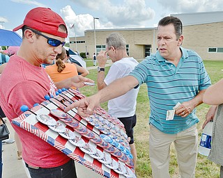 Jeff Lange | The Vindicator  SAT, JUL 30, 2016 - Ed Tulanko of Warren (right) picks out a political pin from a Hillary volunteer while waiting to enter Saturday's rally at East High School.