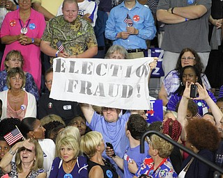 Nikos Frazier | The Vindicator..A protestor holds a "election Fraud" sign in the East High School gym before Democratic Presidential candidate Hillary Clinton spoke on Saturday night.