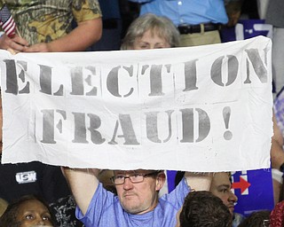 Nikos Frazier | The Vindicator..A protestor holds a "election Fraud" sign in the East High School gym before Democratic Presidential candidate Hillary Clinton spoke on Saturday night.