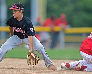 Game 1BOARDMAN, OHIO - JULY 31, 2016: Ben Slanker #14 of Canfield gets his glove down to field the ball while Matt Jones #42 of Dover steals second base in the seventh inning of Game 1 of Sunday afternoon Little League Championship DoubleHeader. Canfield won 7-6 in 7 innings. DAVID DERMER | THE VINDICATOR
