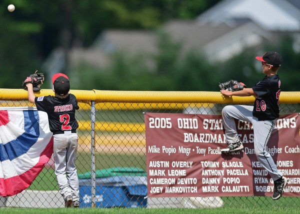 Game 2BOARDMAN, OHIO - JULY 31, 2016: Left fielder Ty Stricko #2 and center fielder Jack Davis #20 of Canfield watch as the ball flies over the fender for a solo home run by Matthew Gigat #5 of Dover in the fourth inning of Game 2 of Sunday afternoon Little League Championship DoubleHeader. Canfield won 7-6 in 7 innings. DAVID DERMER | THE VINDICATOR