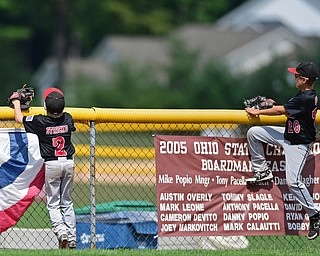Game 2BOARDMAN, OHIO - JULY 31, 2016: Left fielder Ty Stricko #2 and center fielder Jack Davis #20 of Canfield watch as the ball flies over the fender for a solo home run by Matthew Gigat #5 of Dover in the fourth inning of Game 2 of Sunday afternoon Little League Championship DoubleHeader. Canfield won 7-6 in 7 innings. DAVID DERMER | THE VINDICATOR