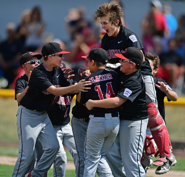 Game 2BOARDMAN, OHIO - JULY 31, 2016: Starting pitcher Ben Slanker #14 of Canfield is mobbed by his teammates including Broc Lowry #27, AJ Havrillay #3, Connor Daggett #5, Jake Schneider #12 after the final strike out of the fourth inning of Game 2 of Sunday afternoon Little League Championship DoubleHeader. Canfield won 7-6 in 7 innings. DAVID DERMER | THE VINDICATOR