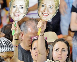 Jeff Lange | The Vindicator  SAT, JUL 31, 2016 - Clinton supporters raise signs with Hillary's face on them during the campaign rally at East High School, Saturday night.