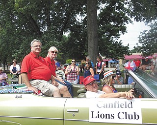 SPECIAL TO THE VINDICATOR
Mary Ann Dzuracky, the new president of the Canfield Lions Club, rode in Canfield’s Fourth of July parade with her husband Andy Dzuracky, who is first vice president. Her term runs from July 1 to June 30, 2017. In the passenger seat is Lion Harry Pancher, owner of the car. The driver is Pancher’s granddaughter, Kelly Brown of Florida, who has driven her grandfather’s car in parades for about 20 years.