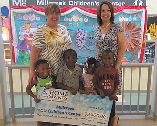 SPECIAL TO THE VINDICATOR
The Charitable Foundation of Home Savings Banks donated $3,500 to Millcreek Children’s Center to support the early childhood development programs at the center. The center is a nonprofit, year-round preschool facility that prepares the children of lower income working families for kindergarten. Mary Jane Gingher, left, the director of Millcreek Children’s Center, accepted the check, along with some of the Center’s children participants on hand, from Trish Mohan, branch manager of the Home Savings main office. For information about the Center and the services they provide, call 330-746-7111 or visit millcreekchildrenscenter.org.
