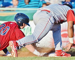 Jeff Lange | The Vindicator  TUE, AUG 2, 2016 - Mahoning Valley's Mitch Longo (30) dives back to first under the tag of Williamsport's Luis Encarnacion in the bottom of the second inning of Tuesday's game at Eastwood Field.