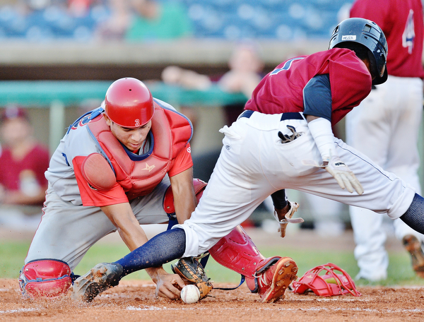 Jeff Lange | The Vindicator  TUE, AUG 2, 2016 - Williamsport catcher Gregori Rivero (left) drops the throw from the outfield as Scrappers' Gabriel Mejia scores in the bottom of the third inning of Tuesday's game at Eastwood Field.