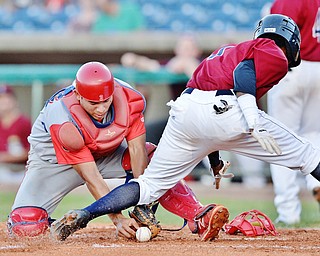 Jeff Lange | The Vindicator  TUE, AUG 2, 2016 - Williamsport catcher Gregori Rivero (left) drops the throw from the outfield as Scrappers' Gabriel Mejia scores in the bottom of the third inning of Tuesday's game at Eastwood Field.