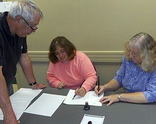 SPECIAL TO THE VINDICATOR
Salem Historical Society is hosting a Hands On History event from 1 to 3 p.m. Tuesday at the Dale Shaffer Library, 239 S. Lundy Ave., for students in grades four through six. Activities include designing a quilt pattern with a secret code like those used during the abolitionist period to help slaves on their quest to freedom, learning how to write with a quill pen and dressing in period costumes. Parental permission forms must be completed either online or at the door. The fee is $3. For information or to register, call 330-337-8514 or visit salemhistoricalsociety.org. Pictured from left are Jerry Laska, coordinator for Hands On History, overlooking Kristy Hinchliffe and Alice Deatherage, society members who are practicing writing with quill pens.