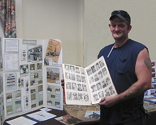 SPECIAL TO THE VINDICATOR
Ward-Thomas Home and Museum, 503 Brown St., Niles, will be the setting of a Heritage Day celebration and open house honoring all veterans from 2 to 5 p.m. Sunday. There will be a display of war memorabilia in the Westenfield room and a Wall of Honor boards honoring deceased veterans. Guests also are urged to explore a large display of old tools in the barn at the museum. Cost will be $5, and children under 12 can enter for free. At right is Dave Rosine displaying a picture book of area men and women serving in the military in World War II.
