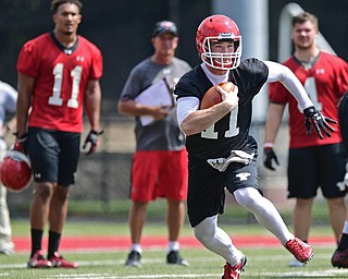 YOUNGSTOWN, OHIO - AUGUST 5, 2016: Quarterback Trent Hosick #11 of YSU runs the football after not finding a open receiver to pass to during a 11 on 11 session of practice Friday afternoon at Stambaugh Stadium. DAVID DERMER | THE VINDICATOR