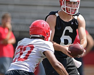 YOUNGSTOWN, OHIO - AUGUST 5, 2016: Quarterback Hunter Wells #6 of YSU looks down field while pulling the football away from Jody Webb #20 during a 11 on 11 session of practice Friday afternoon at Stambaugh Stadium. DAVID DERMER | THE VINDICATOR