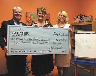 SPECIAL TO THE VINDICATOR | Talmer Bank and Trust recently donated $2,500 to Northeast Ohio Adoption Services for the creation of a Talmer Kids’ Activity Room which will feature an activity table, television, tablets, games and therapeutic activities for children ages 10 and under. The room will be used when children at NOAS are in transfer, for official meetings, and as a gathering place for a Parent Resource Group that offers training, mentorship and support for foster and adoptive parents while children are provided dinner, activities and child care. NOAS relies on donations and fundraising to recruit and prepare families to foster or adopt; the facility does not charge fees for placement. For information on supporting NOAS, visit www.noas.com or call 330-856-5582, ext. 126, to receive an information packet. Above, are Mark Wenick, left, executive managing director and region president for Mahoning Valley Talmer Bank and Trust, who recently presented the donation to Cheryl Tarantino, executive director for NOAS, with the assistance of Sharon DeFrances, managing director of private client services for Talmer.