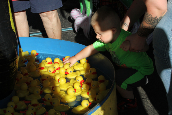 Nikos Frazier | The Vindicator..Lucas Rovnyak, 1 of Brookefield, reaches for a rubber duck at the St. Patrick Parish Festival in Hubbard.