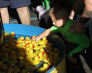 Nikos Frazier | The Vindicator..Lucas Rovnyak, 1 of Brookefield, reaches for a rubber duck at the St. Patrick Parish Festival in Hubbard.