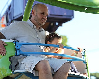 Nikos Frazier | The Vindicator..Kenny Feaster and his daughter Lily, 6, of Dover, Delw. ride the ferris wheel at the St. Patrick Parish Festival in Hubbard.