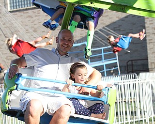 Nikos Frazier | The Vindicator..Kenny Feaster and his daughter Lily, 6, of Dover, Delw. ride the ferris wheel at the St. Patrick Parish Festival in Hubbard.