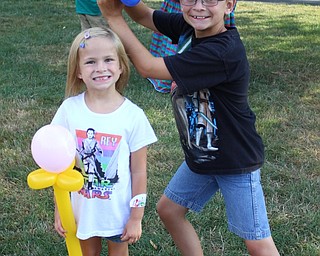 Neighbors | Abby Slanker.Addison and Logan Malysa of Boardman prepared to watch “Star Wars: The Force Awakens” by having balloon light sabers made by Jocko the Balloon Man at Boardman Park’s Family Night in the Park on July 16.