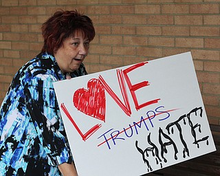 Nikos Frazier | The Vindicator..Geri DeWitt holds a freshly made "Love Trumps Hate" sign outside the Kilcawley Center at the Youngstown State University.