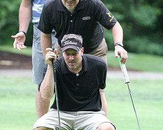 William D. Lewis The Vindicator Mike Marzich of the Farmers Bank team lines up a putt during GGOV Scramble Aug. 15, 2016 at the Lake Club. Looking on are team membersJohn Lacy and Kevin Helmick