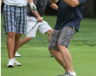 William D. Lewis The Vindicator Donny Murphy of the Donnell Ford Scramble team reacts to a putt during GGOV Scramble Aug. 15, 2016 at the Lake Club. Looking on are team members John Morvay, left, and Pet Bernat.