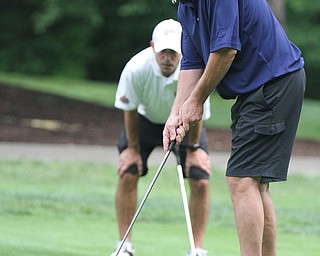 William D. Lewis The Vindicator Joe McHenry of the Superior Beverage Team  putts during GGOV Scramble Aug. 15, 2016 at the Lake Club. In background is Paul Corto