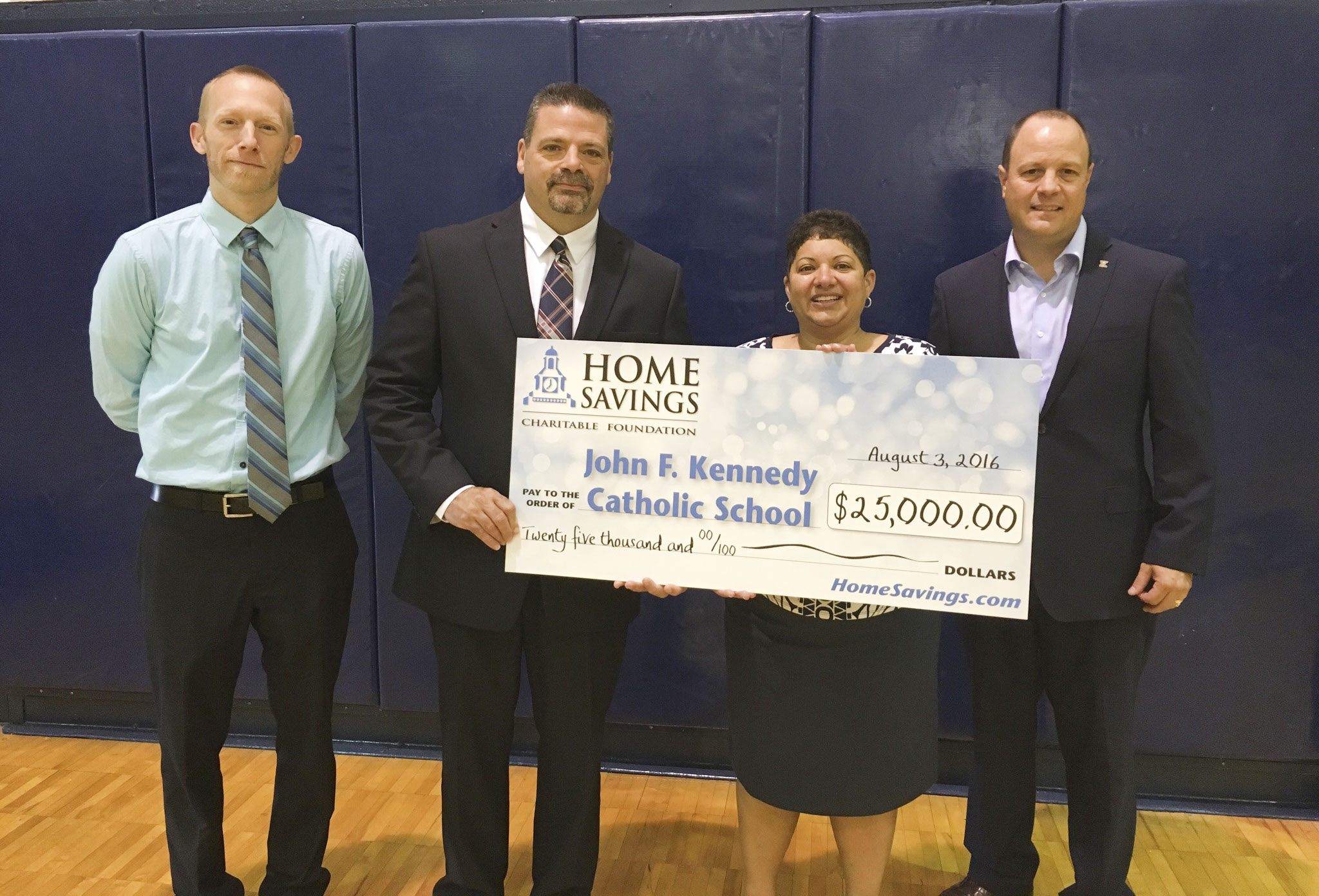 SPECIAL TO THE VINDICATOR
John F. Kennedy Catholic School recently received a donation of $25,000 from Home Savings Charitable Foundation. The school plans to upgrade the boiler system, windows and lighting to generate energy savings. From left, are Mark Komlanc, head basketball coach of JFK, Joseph Kenneally, president of JFK; Nancy Tabor, Trumbull County area manager of Home Savings; and Chris Litton, director of advancement and alumni relations at JFK. For information about the school, call 330-369-1804 or visit warrenjfk.com.