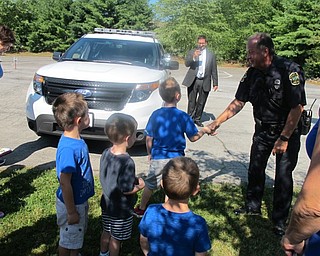 Neighbors | Alexis Bartolomucci.The students at Hitchcock Woods Daycare shook hands with Officer Mike during his visit on July 19.