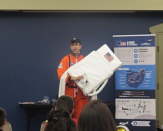 Neighbors | Alexis Bartolomucci.An Armstrong Air and Space Museum representative held up a backpack that astronauts use when they go up to space.