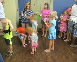 Neighbors | Alexis Bartolomucci.Children played with miniature catapults during the Air and Space program at the Boardman library on July 22 to try and shoot a piece of rolled up paper into the trashcan.