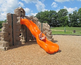 Neighbors | Alexis Bartolomucci.Children took turns sliding down the slide and rock wall sets at the Walter Terlecky playground at Austintown Township Park.
