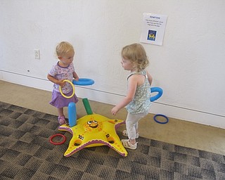 Neighbors | Alexis Bartolomucci.Two of the children at the Pete the Cat event at the Austintown library on July 27 played ring toss with each other.