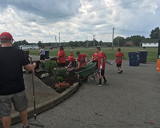 Neighbors | Abby Slanker.Canfield Little Cardinals football players and cheerleaders, along with their coaches and board members, volunteered to plant flowers and mulch an area of the Canfield Fairgrounds on July 31.