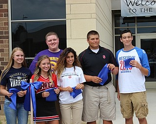 Neighbors | Abby Slanker.Students representing Mahoning County Educational Service Center member districts, including Canfield High School student Alexis Hudock (front), were given a piece of the ribbon they had just cut as a souvenir of the opening of the new facility on Aug. 4.